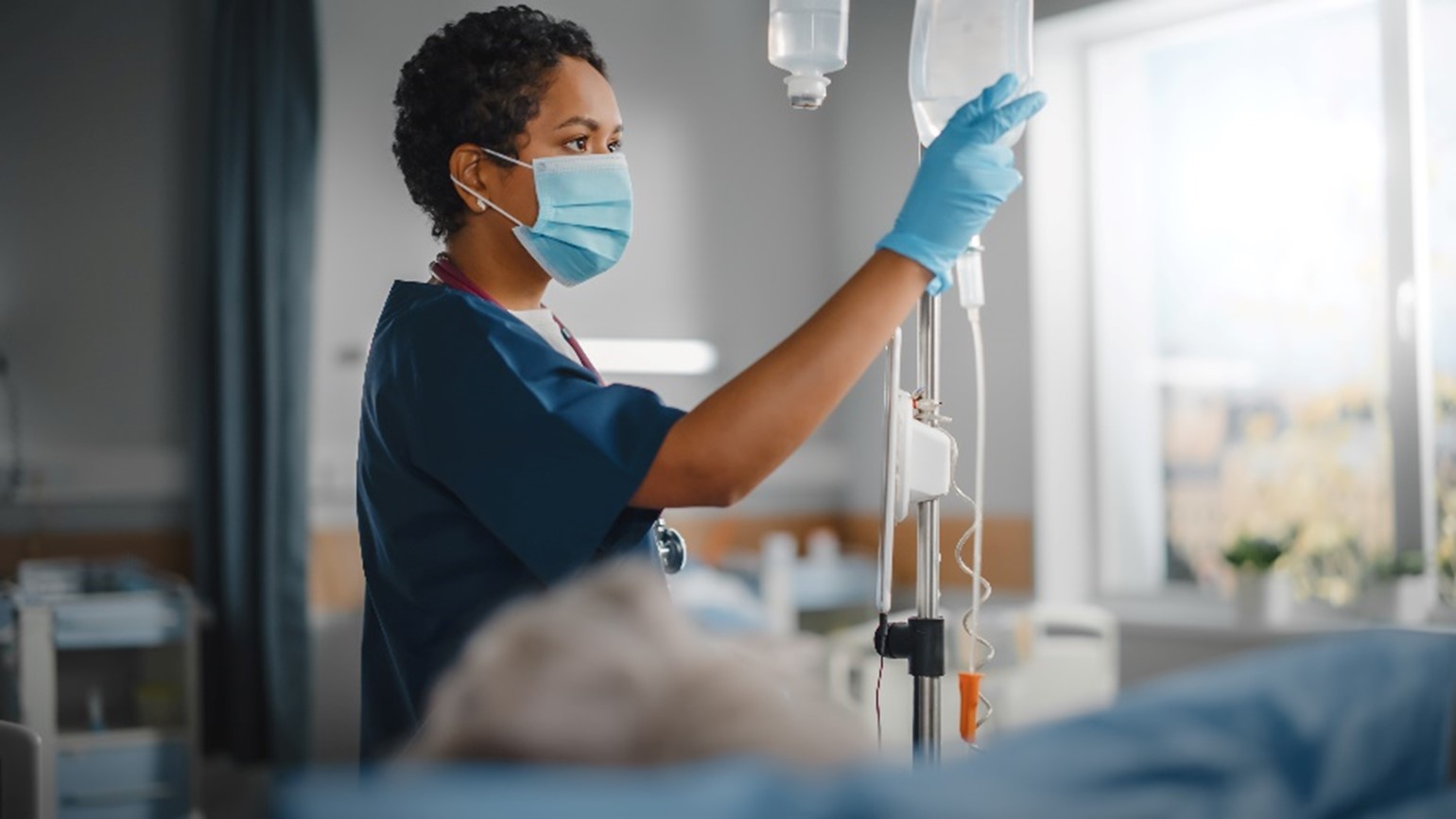 Nurse adjusting intravenous drip