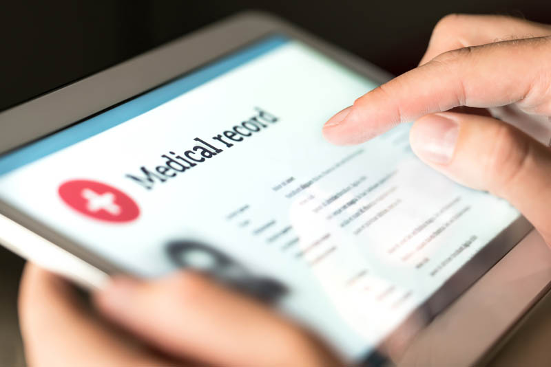 Close up of a tablet with the words 'Medical record' on it