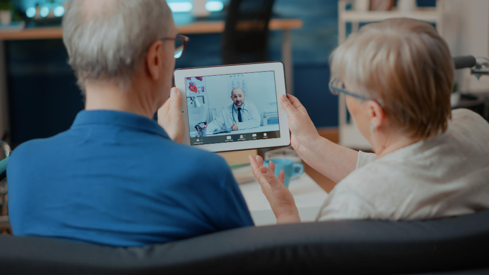 senior couple attending online meeting with doctor