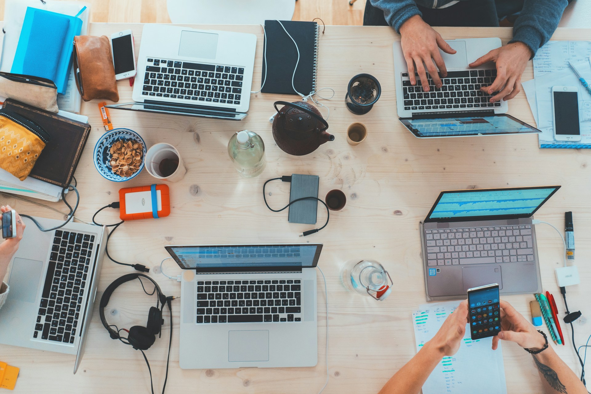 Desk with many devices scattered around.