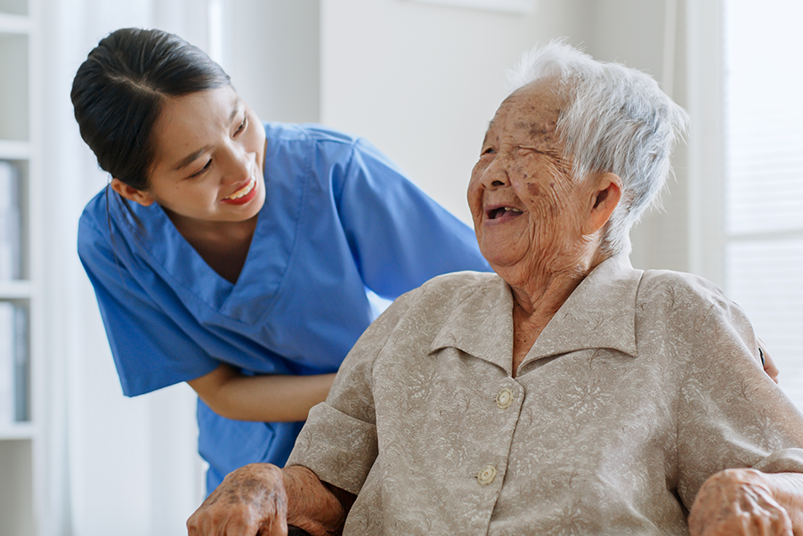 Health care worker with patient who is laughing